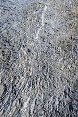 Roughly textured medium gray rock, as a nature background
