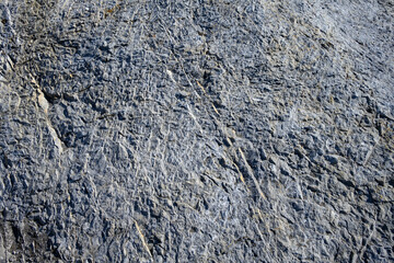 Roughly textured medium gray rock, as a nature background
