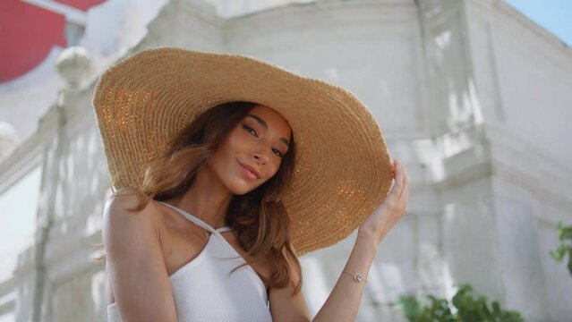 Elegant woman straw hat posing beautiful summer closeup. Portrait chic model