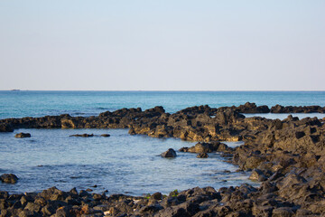 Fototapeta na wymiar It is a beach with black basalt rocks.