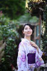 Japanese woman in yukata in green park