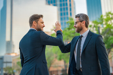 Businessman handshake with partner. Two businessmen shaking hands outdoor. Business mens growth strategy. Business men with proposal to the client. Collaborated on a project.