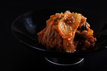 Korea food cabbage kimchi in black isolated in black background