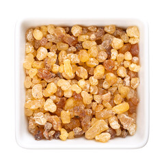 Frankincense resin in a white bowl. Small pieces of hardened aromatic olibanum resin, obtained from...