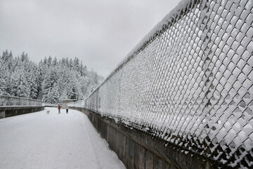 Fototapeta premium Snowy winter landscape at the Cleveland Dam and Capilano River Regional Park in North Vancouver, British Columbia, Canada