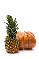 Ripe pumpkin and pineapple on a white background