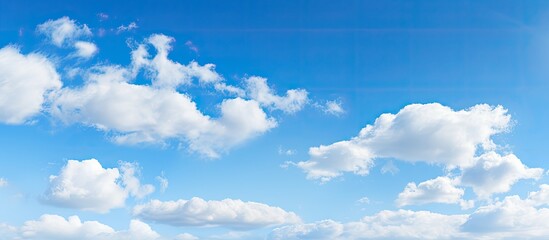 Scattered stratus clouds in a clear blue sky on a sunny autumn day make a serene and picturesque view.
