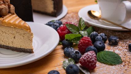 close-up of a light cup with coffee, macaron with cream filling, decorated with fresh berries, blueberries and raspberries, festive New Year's cake, Christmas