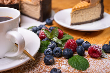 close-up of cheesecake with cream filling, decorated with fresh berries, blueberries and raspberries, festive New Year's cake, Christmas. From above