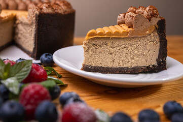 close-up of cheesecake with cream filling, decorated with fresh berries, blueberries and raspberries, festive New Year's cake, Christmas. From above