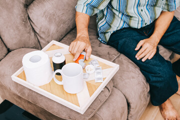 Close up of senior man taking prescription medicine at home