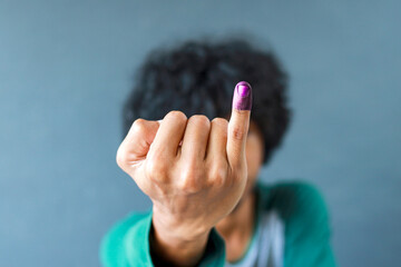 Man showing little finger after voting on Indonesia's presidential election 