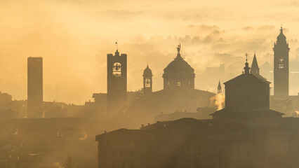 Bergamo, Italy. Amazing aerial landscape of the fog rises from the plains and covers the old town...