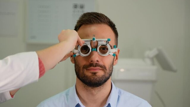 Customer in a vision test or eye exam for eyesight by doctor, optometrist or ophthalmologist with medical aid