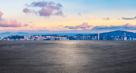 Asphalt road square and city skyline with coastline landscape at sunset in Zhuhai, Guangdong Province, China.