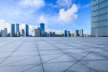 Empty square floors and city skyline with modern buildings scenery under blue sky