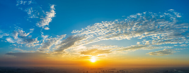 Panoramic sunset sky and clouds background. Aerial view.