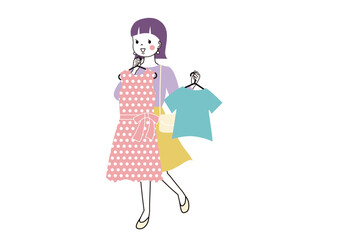 洋服を胸にあてながら選んでいる女性