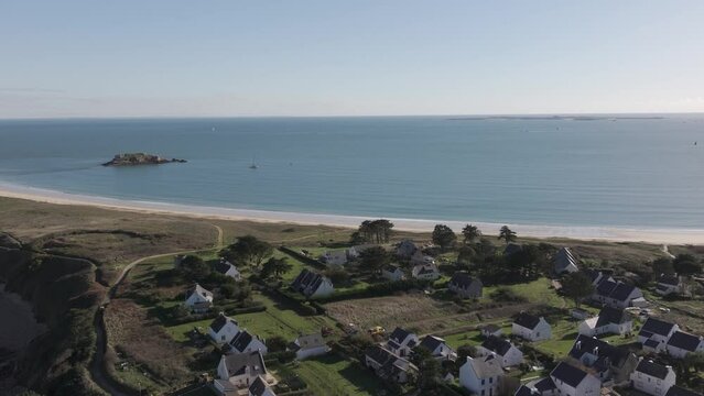 Village of Houat in the island of the same name near Bay of Quiberon on the Brittany Atlantic coast of France, Aerial pan left shot