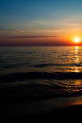 Sunset over the water on a dark background of sunlight over the Mediterranean Sea