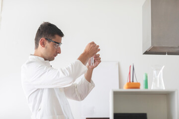 scientist male with lab glasses and gloves working in a laboratory