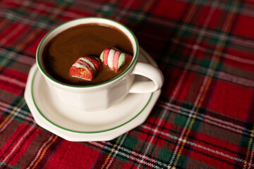 Obraz na płótnie Canvas hot chocolate with marshmallows on Christmas tablecloth