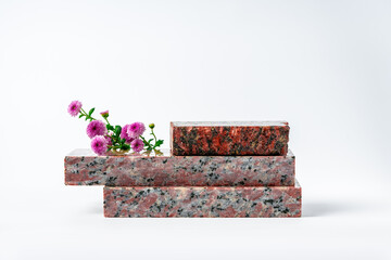 Polished granite stones with small flowers studio shot