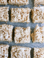 overhead rice krispie treat on parchment and blue background