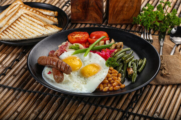Traditional Engrlish breakfast with egg  and sausages
