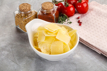 Sliced parmesan cheese in the bowl