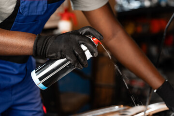 Close up of hands of auto mechanic working in a garage