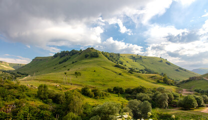 Green mountains in summer against the background of the sky with clouds