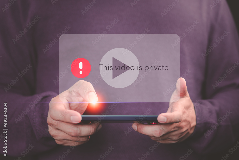 Poster Young man using a mobile phone to play social media but this video is blocked or privacy settings have been set. Searching for more internet, and search engine optimization. Subscribing and following.