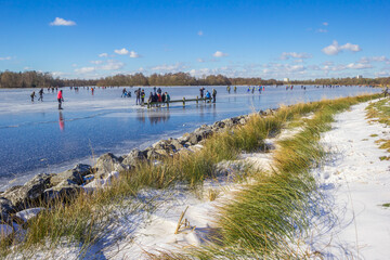 Snow at the shore of the frozen lake in Paterswolde, Netherlands
