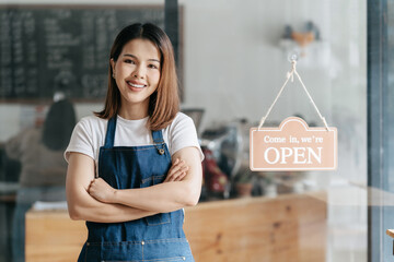 Asian Happy business woman stand with arms crossed, the owner of the cafe stands at the door with a...