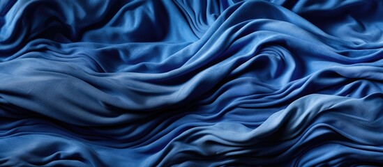 background, a rumpled blue fabric, resembling a wave, served as wallpaper, covering the bed with its textured texture, woven from cotton, canvas, and linen threads, resembling a jam spread across the
