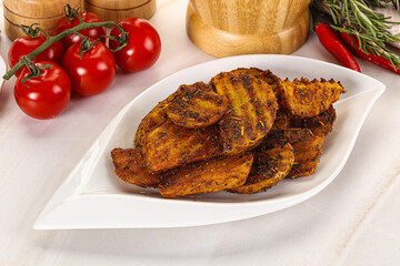 Golden baked potato Idaho with spices