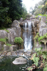 Waterfall cascade on mountain rocks.