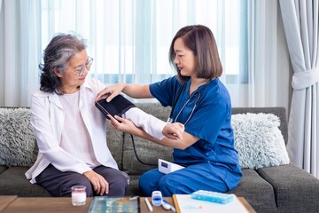 Senior woman got medical service visit from caregiver nurse at home while having blood pressure...