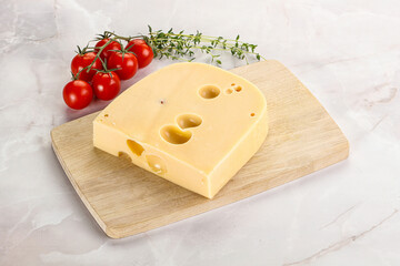 Maasdam cheese brick over board
