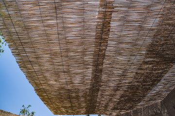 Reed roofing protects from heat and creates shade in hot climates in the cities of Central Asia, pattern