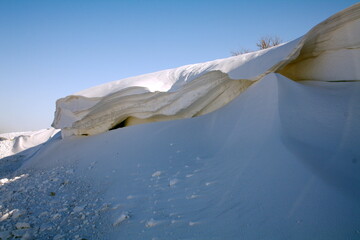 huge beautiful snowdrift after a strong snowstorm along the highway sunny day