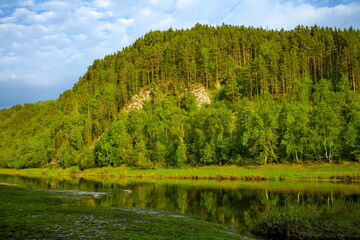 beautiful Belaya river flowing in the Southern Urals among rocky mountains and forests on a summer day