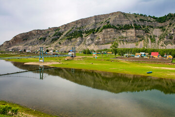 Obraz premium Bashkir village Tash asty on the Zilim river opposite the Kaya rock in the Southern Urals
