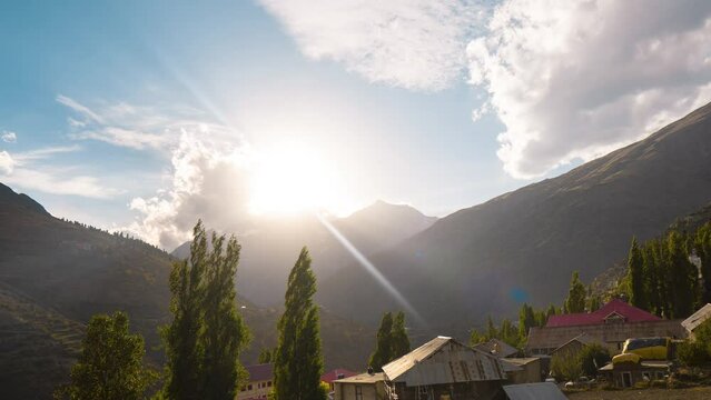 4k time lapse of sunset over Himalayas during summer evening. Sunset on mountains. Summer landscape of mountains, clouds and tree. Sun setting over small town in Himachal Pradesh