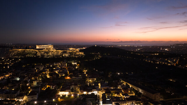 Cityscape with the illuminated Parthenon and Acropolis in distance at night, Athens, Attica, Greece