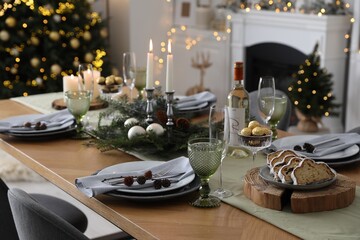 Fototapeta premium Christmas table setting with festive decor and dishware in living room