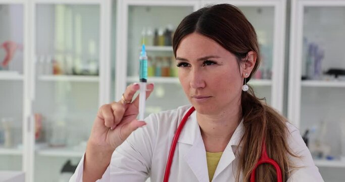 Nurse doctor portrait of medical worker with syringe in hands