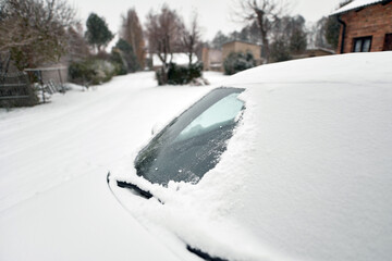 A Frozen Car Windshield Covered with Snowflakes in a Winter Storm. A Close-Up of a Car Windshield...