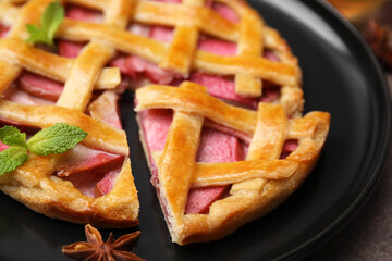 Delicious apple pie with mint on table, closeup